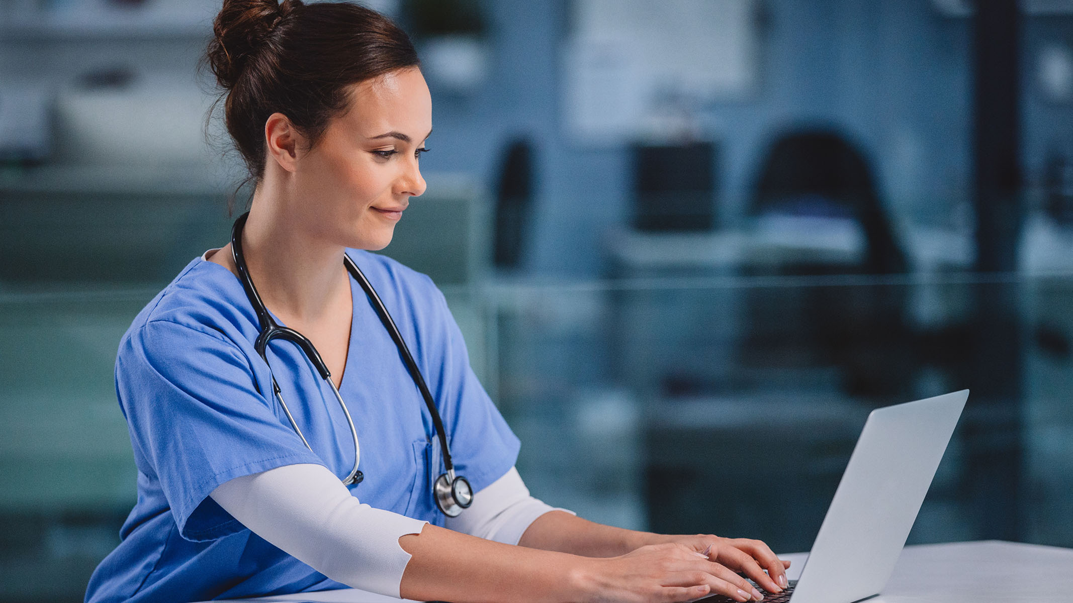 Profesional de la salud usando un computador portátil.​​ 